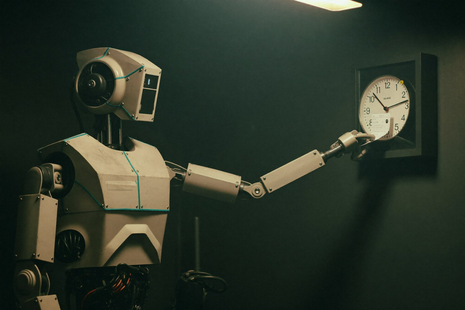 An industrial robot punching a timecard at a factory wall clock